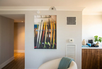 Modern interior with a wall art piece of surfboards on a light gray wall.