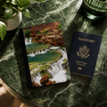 Passport and passport holder with waterfall design on a marble surface