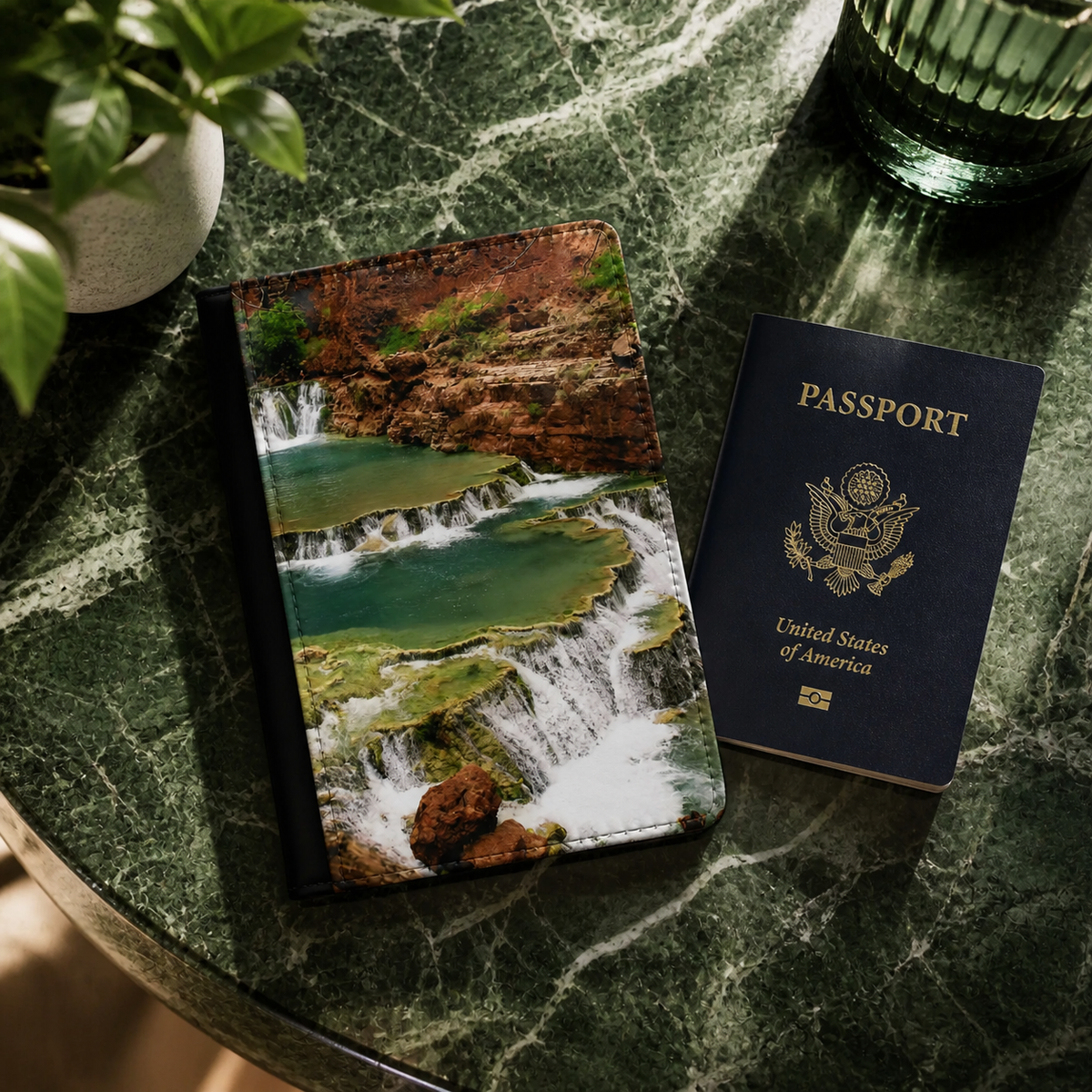 Passport and passport holder with waterfall design on a marble surface